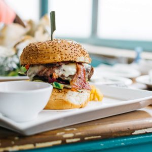 juicy-burger-in-a-vibrant-colorful-interior-FX2VZ6W